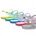 Jelly ballet style shoes with buckle fastening for beach and pool use.