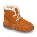 Suede leather kids ankle boots with laces and fake hair lined.