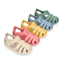 Children's barefoot jelly shoes with adhesive closure for the beach and pool.