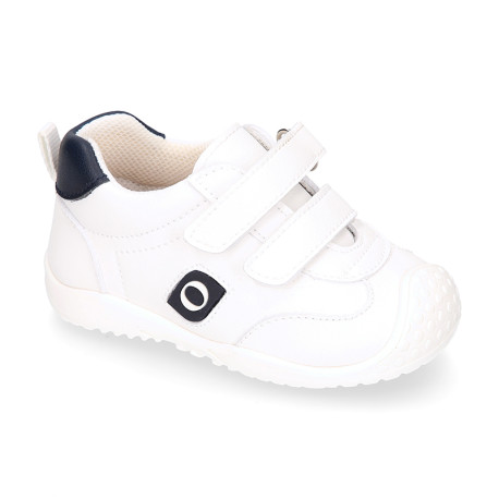 White color OKAA FLEX tennis kids shoes laceless and with toe cap.