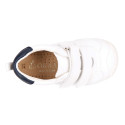 White color OKAA FLEX tennis kids shoes laceless and with toe cap.