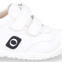 White color OKAA FLEX tennis kids shoes laceless and with toe cap.