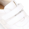 White color OKAA FLEX tennis kids shoes laceless and with toe cap.