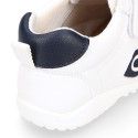 White color OKAA FLEX tennis kids shoes laceless and with toe cap.