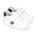 White color OKAA FLEX tennis kids shoes laceless and with toe cap.